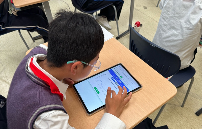 Student using tablet to submit classroom interaction task